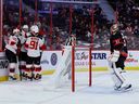 Devils players celebrate a goal by centre Jesper Boqvist against Senators netminder Anton Forsberg in the second period of Saturday afternoon's game.