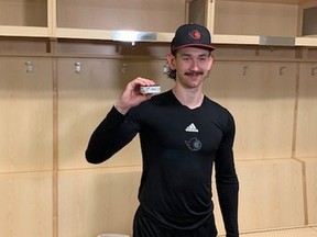 Ottawa Senators' Jake Sanderson holds the puck for his first NHL goal on November 23, 2022.