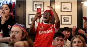 Jamal Mbaye watches the Canada-Belgium game at the Glebe Central Pub on Wednesday afternoon.