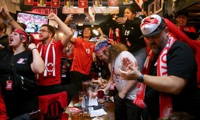 From left to right, Jessie Porter, Josh Geauvreau, Vahid Seddigh, Patrick Gibson, Faith Haifa (on the table) and Bryce Crossman (far right) will watch the game at the Glebe Central Pub on Wednesday afternoon.