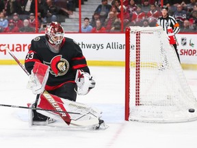 File photo/ Cam Talbot of the Ottawa Senators tracks the puck after making a save during the first period against the Montreal Canadiens as a stick flies in front of him at Canadian Tire Centre.