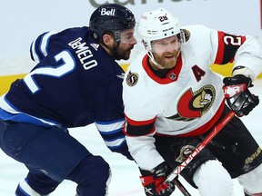 Ottawa Senators forward Claude Giroux (right) is impeded by Winnipeg Jets defenceman Dylan DeMelo in Winnipeg on on Tuesday night.