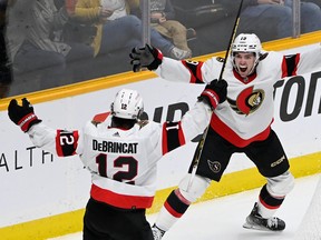 Ottawa Senators winger Drake Batherson (19) celebrates with Alex DeBrincat after DeBrincat scored a goal against the Nashville Predators on Saturday.