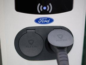 A Ford logo is seen on an electric vehicle charging point during a press event, Dec. 1, 2022.