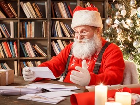 Santa Claus in the library reading letters.