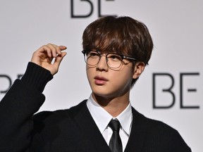 South Korean K-pop boy band BTS member Jin poses for a photo session during a press conference on BTS new album 'BE (Deluxe Edition)' in Seoul on Nov. 20, 2020.