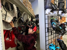 ristan Stoneking (11) from the Orange County Hockey Club in Southern California, picks out all new goalie gear at Play It Again Sports in Kanata Wednesday.