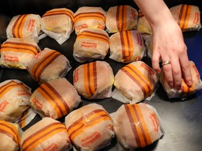 An employee places burgers at the new restaurant "Vkusno & tochka", which opens following McDonald's Corp company's exit from the Russian market, in Moscow, Russia June 12, 2022.