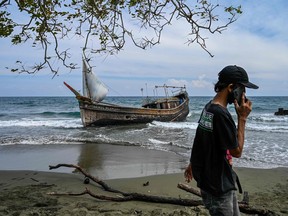 This picture shows a boat that was carrying Rohingya refugees after their arrival at a beach in Krueng Raya, Indonesia's Aceh province on Dec. 25, 2022.