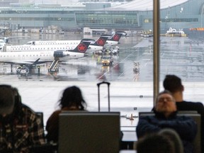 Air Canada planes are prepared as people wait to check into their flights during a winter storm at Toronto Pearson International Airport in Mississauga, Ontario, Dec. 23, 2022.