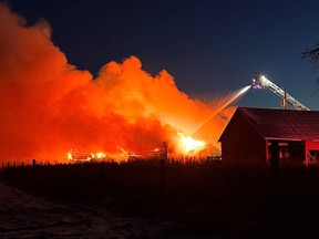 Ottawa firefighters battle a blaze at a barn in the rural southeast portion of the city on Tuesday.
