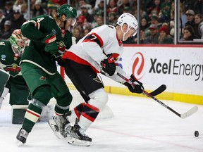 Ottawa Senators left wing Brady Tkachuk (7) and Minnesota Wild defenceman Jon Merrill (4) battle for the puck during the third period at Xcel Energy Center, Dec. 18, 2022.