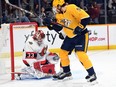 Senators goaltender Cam Talbot makes a save as Predators winger Filip Forsberg crosses in front of the net during the first period of Saturday's game in Nashville.