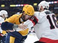 Senators winger Auston Watson scraps with the Predators' Jeremy Lauzon during the second period of Saturday's game in Nashville.