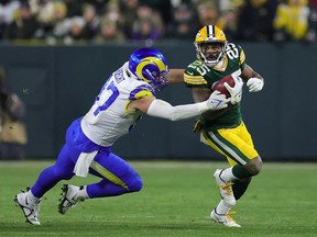 Keisean Nixon of the Green Bay Packers is pursued by Michael Hoecht of the Los Angeles Rams during a game at Lambeau Field on December 19, 2022 in Green Bay, Wisconsin. The Packers defeated the Rams 24-12.