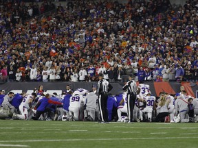 Buffalo Bills players huddle and pray after teammate Damar Hamlin #3 was injured against the Cincinnati Bengals during the first quarter at Paycor Stadium on January 02, 2023 in Cincinnati, Ohio.