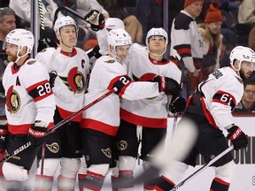 Artem Zub #2 of the Ottawa Senators celebrates with Claude Giroux #28, Brady Tkachuk #7, Austin Watson #16 and Derick Brassard #61 after scoring an empty-net goal against the Arizona Coyotes during the third period of the NHL game at Mullett Arena on January 12, 2023 in Tempe, Arizona. The Senators defeated the Coyotes 5-3.