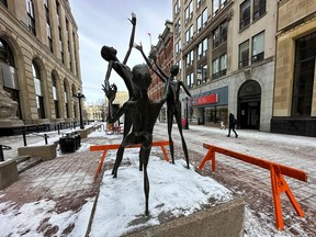 Some damaged and hanging pieces of the "Joy" statue at the Sparks Street Mall were removed and barricades were set up to keep pedestrians away after vandals allegedly damaged the statue earlier this week. Pictured Wednesday, Jan. 11, 2023.
