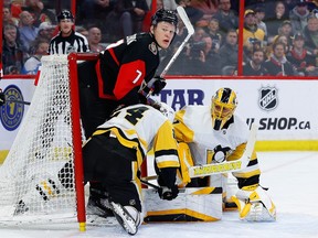 Ottawa Senators left wing Brady Tkachuk (7) gets tangled up with Pittsburgh Penguins defenceman Ty Smith and goaltender Casey DeSmith during the first period at the Canadian Tire Centre on Wednesday, Jan. 18, 2023.