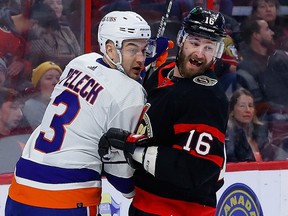 Ottawa Senators left wing Austin Watson and New York Islanders defenceman Adam Pelech battle during the first period at the Canadian Tire Centre on Wednesday, Jan. 25, 2023.