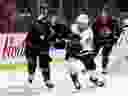 Ottawa Senators captain Brady Tkachuk (left) battles Seattle Kraken centre Alex Wennberg on Saturday, Jan. 7. The level of interest in purchasing the Senators could drive the asking price to anywhere between $800 million to $1 billion US.