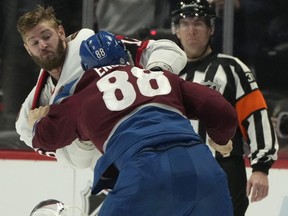 Ottawa Senators left wing Austin Watson, left, fights with Colorado Avalanche defenceman Andreas Englund (88) in the second period in Denver Saturday night.