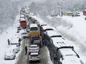 Vehicles are stuck on a highway in heavy snow in Pyeongchang, South Korea, Sunday, Jan. 15, 2023.