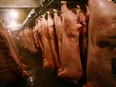 A pig -- stunned and about to be butchered -- regained consciousness and killed a slaughterhouse worker while flailing around. Pictured: A worker checks slaughtered pork at a united meat machining workshop on Aug. 3, 2007 in Nanjing of Jiangsu Province, China.