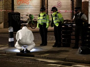 Forensics officers work at the scene of a shooting, which reportedly happened during a funeral at St Aloysius Church, in London, England, Saturday, Jan. 14, 2023.