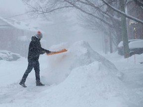 A person shovels more snow in Ottawa.