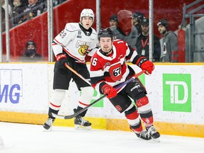 New 67’s acquisition Logan Morrison follows the play as he circles away from Owen Sound Attack defenceman James Petrovski yesterday at TD Place.  Morrison had three assists in his Ottawa debut.