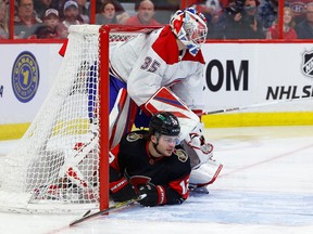 Senators right-winger Alex DeBrincat slides into the net of Canadiens goaltender Sam Montembeault in the first period. DeBrincat would later score Ottawa's first goal.