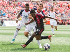 Daniel Kinumbe (23) of Ottawa Fury FC tries to control the ball as he is marked by Karl Ouimette of Indy Eleven during a United Soccer League match at TD Place Stadium in Ottawa, ON. Canada on August 18, 2018.  the game ended in a 0-0 draw. PHOTO: Steve Kingsman/Freestyle Photography for Ottawa Fury FC