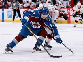 Colorado Avalanche left wing Artturi Lehkonen controls the puck ahead of Ottawa Senators defenceman Jake Sanderson in the second period at Ball Arena, Saturday night.