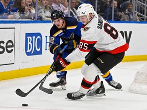 Ottawa Senators defenceman Jake Sanderson works against the Blues' Noel Acciari during Monday night's 2-1 loss in St. Louis. The defencemen earned praise from coach D.J. Smith for their play in the losing effort.