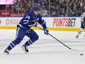 Toronto Maple Leafs forward Auston Matthews tries to get control of a puck against the Winnipeg Jets during the first period at Scotiabank Arena.
