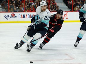 Ottawa Senators left winger Brady Tkachuk pursues Seattle Kraken defenceman Carson Soucy.