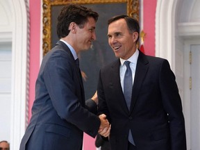 In this file photo, Prime Minister Justin Trudeau shakes hands with then-finance minister Bill Morneau during a ceremony at Rideau Hall on Nov. 20, 2019.