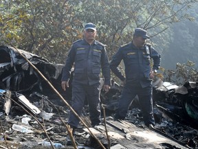 Rescuers inspect the wreckage at the site of a plane crash in Pokhara on January 15, 2023.