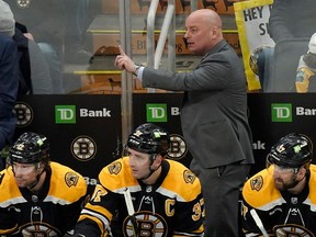 Boston Bruins head coach Jim Montgomery points from the bench during the third period against the San Jose Sharks in Boston on Jan. 22, 2023.