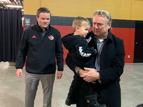 Brendan Bowness with his grandfather, Rick Bowness, as his father, Ryan Bowness, looks on at the Canadian Tire Centre on Saturday, Jan. 21, 2023.