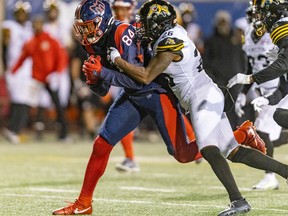 MONTREAL, QUE.: \September\ 23, 2022 --  Montreal Alouettes receiver Reggie White, Jr. is brought down by Hamilton Tiger-Cats Cariel Brooks during second half of Canadian Football League game in Montreal Friday September 23, 2022.