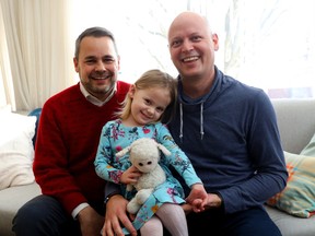 Danny Neville, right, and Matt Wilson, and their daughter, Lily Wilson, 3, with the Jeffy after Lily's favourite stuffed toy was found at the corner of Slater and Elgin.