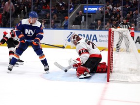 Kevin Mandolese #70 of the Ottawa Senators makes an overtime save against Bo Horvat #14 of the New York Islanders during their game at UBS Arena on Tuesday.