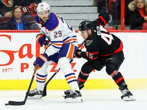 Ottawa Senators left wing Parker Kelly (45) checks Edmonton Oilers centre Leon Draisaitl (29) during first period NHL action at the Canadian Tire Centre on Saturday, Feb. 11, 2023.