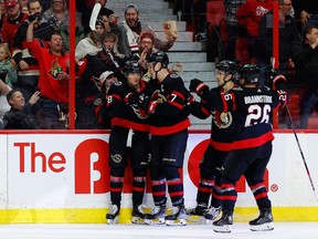Ottawa Senators teammates congratulate left wing Tim Stutzle (18) on his goal against the St. Louis Blues during third period NHL action at the Canadian Tire Centre on Sunday, Feb. 19, 2023.