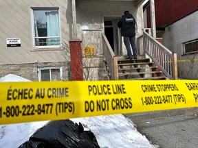 OTTAWA -- A member of the Ottawa Police Service (OPS) Forensic Identification Section (FIS) enters a residence at 209 York Street. Tuesday, Feb. 21, 2023 -- . ERROL MCGIHON, Postmedia