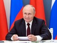 BEHIND HIS SWEET SMILE HE'S CRYING BITTER TEARS: Russian President Vladimir Putin holds a meeting via video conference with Chinese President Xi Jinping (not seeen) at the Kremlin in Moscow, June 28, 2021.