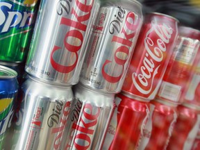 Cans of Sprite, Diet Coke and Coca-Cola are offered for sale at a grocery store.