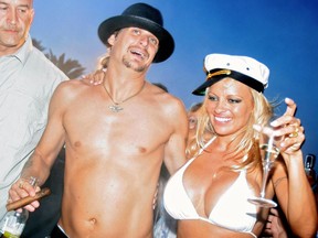 Canadian actress Pamela Anderson shares a drink with her husband, U.S. musician Kid Rock, the day of their wedding, on Pampelone's beach in Saint-Tropez, Southern France, July 29, 2006.